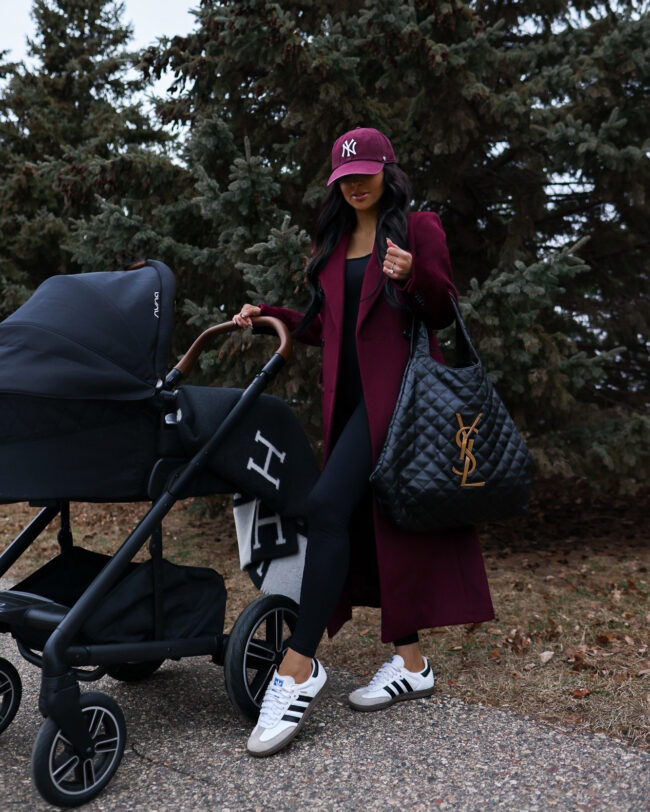mia mia mine wearing a burgundy coat and adidas samba sneakers