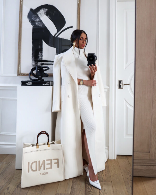 mia mia mine wearing a white maxi coat by naked wardrobe