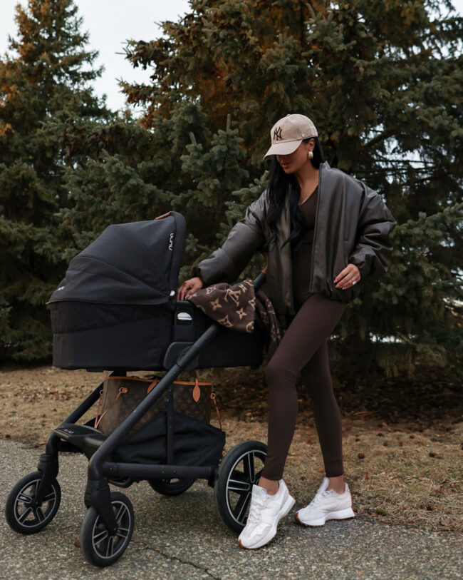 mia mia mine wearing a chocolate brown jumpsuit from alo