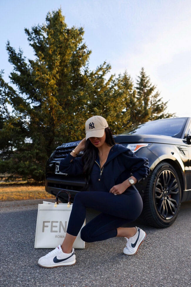 fashion blogger mia mia mine wearing a navy blue workout set from lululemon