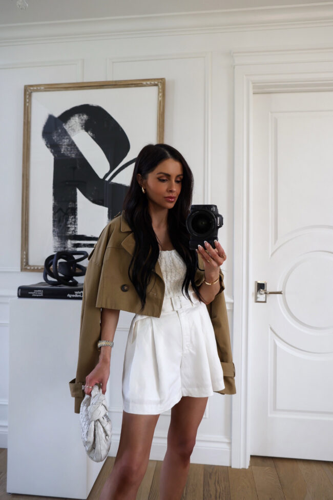 brunette fashion blogger wearing belted white shorts for summer