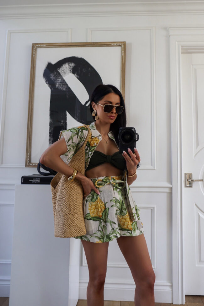 fashion blogger mia mia mine wearing a farm rio pineapple swimsuit coverup