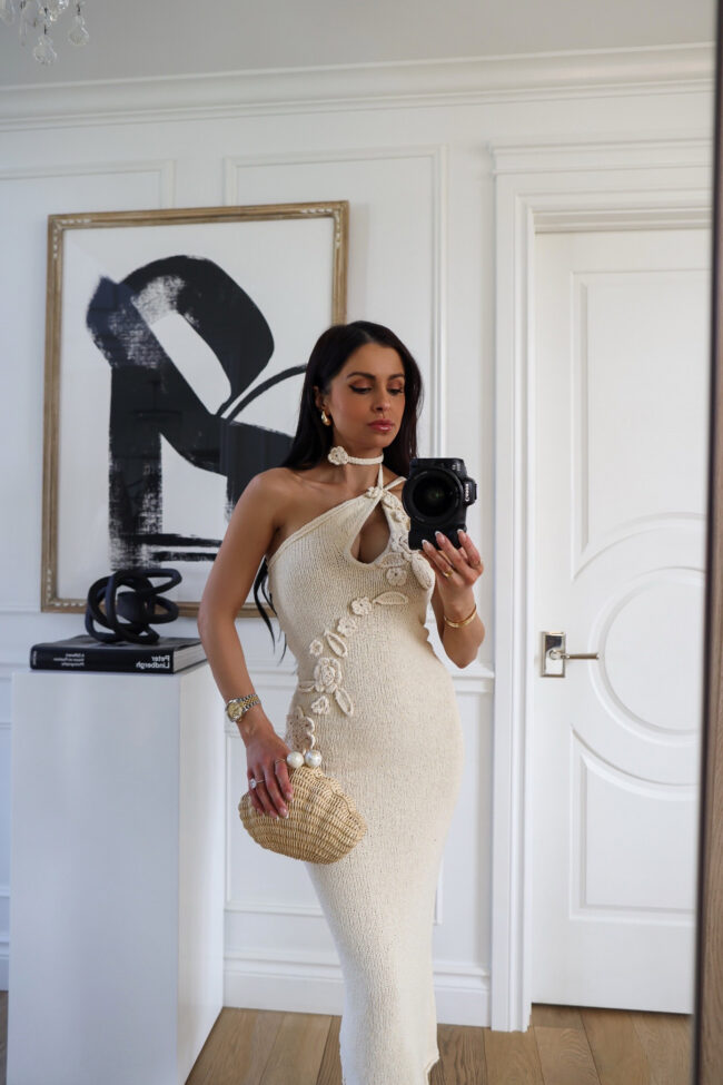 fashion blogger wearing a poolside shell clutch
