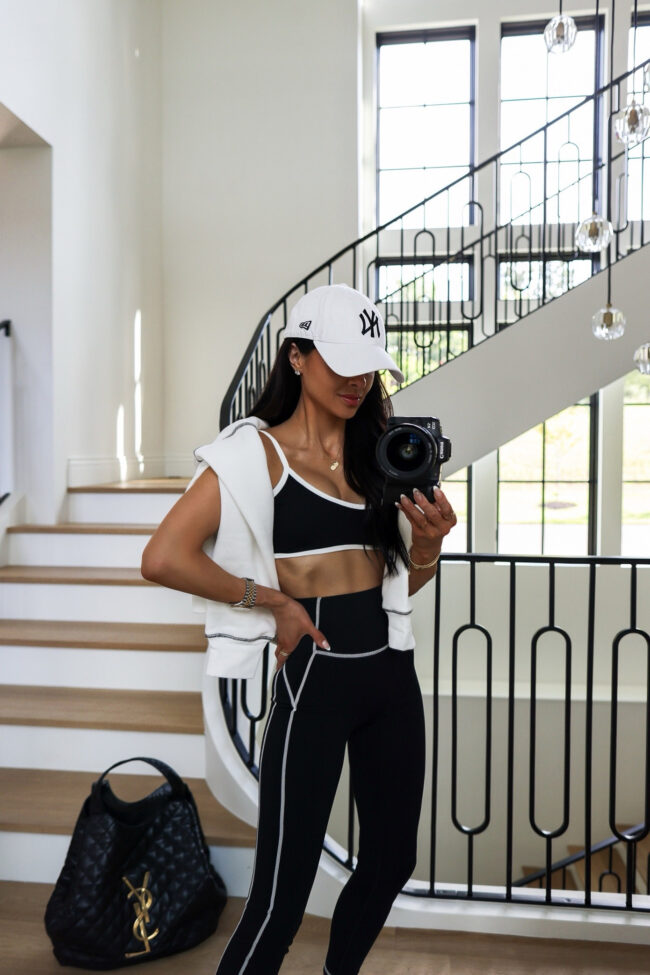 fashion blogger mia mia mine wearing a white piped activewear set from amazon