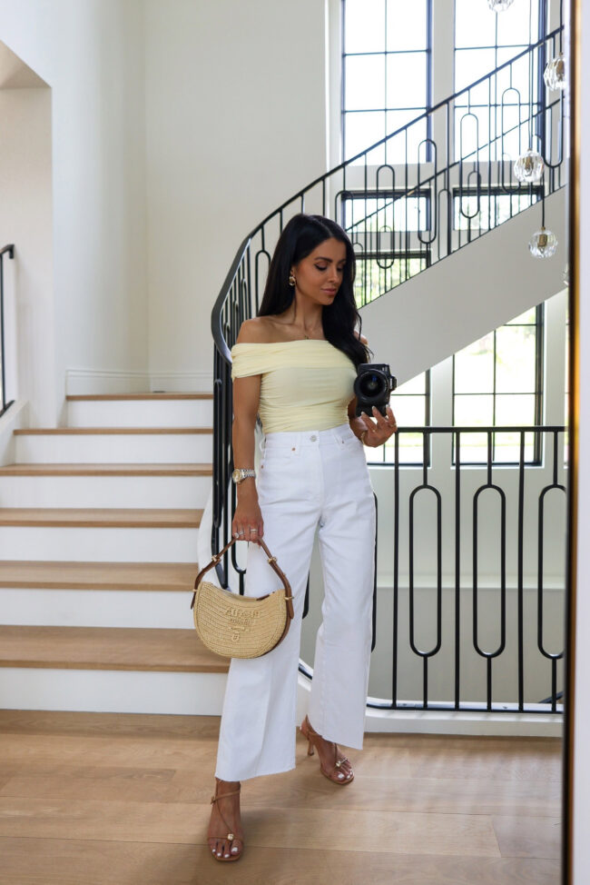 fashion blogger mia mia mine wearing a butter yellow top from saks fifth avenue