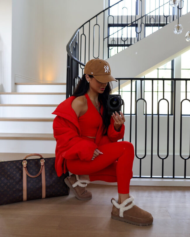 brunette fashion blogger wearing a red activewear set from the nordstrom sale